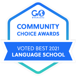 Blue hexagon-shaped award banner displays Community Choice Awards, and Voted Best 2021 Language School.