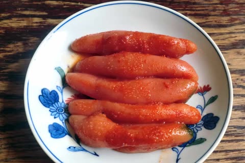 Spicy, red fish eggs arranged on a decorative plate.