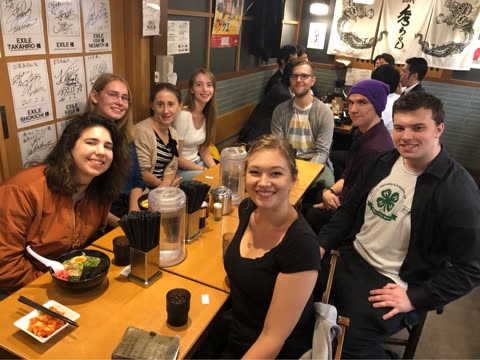 Group of people sitting at a restaurant table in Japan.