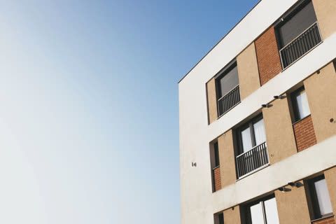 Modern apartment building against a clear blue sky.